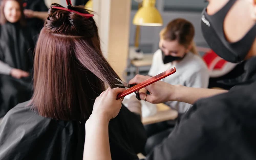 A stylist sectioning a client's hair